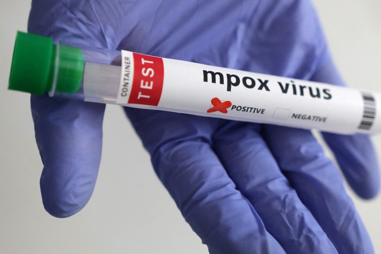 A test tube labelled "Mpox virus positive" is held in this illustration taken August 20, 2024. REUTERS/Dado Ruvic/Illustration