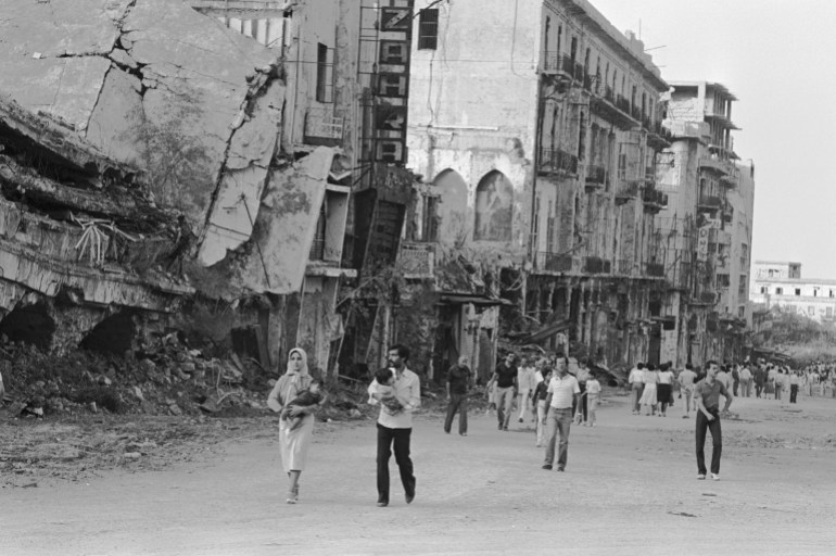 People of Beirut stroll along destroyed and damaged buildings. The ruins testify to the intense fighting going on in the city since June 1982 as a result of Operation Peace For Galilee, when Israeli forces invaded West Beirut in response to repeated cease fire breeches by the Palestine Liberation Organization. The United Nations intervened in September of the same year to force the withdrawal of PLO and Syrian forces and restore Lebanese government, but not before many parts of the city had been reduced to desolate stretches of rubble and debris. (Photo by Alain Nogues/Sygma/Sygma via Getty Images)