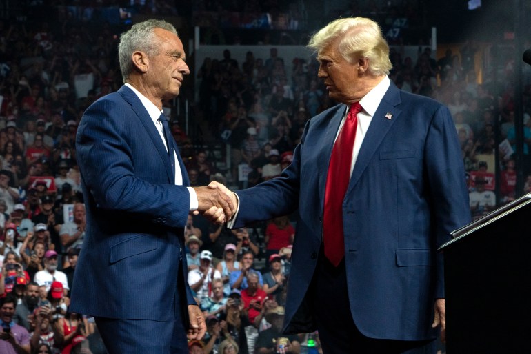 GLENDALE, ARIZONA - AUGUST 23: Former Republican presidential candidate Robert F. Kennedy Jr. and Republican presidential nominee, former U.S. President Donald Trump shake hands during a campaign rally at Desert Diamond Arena on August 23, 2024 in Glendale, Arizona. Kennedy announced today that he was suspending his presidential campaign and supporting former President Trump. Rebecca Noble/Getty Images/AFP (Photo by Rebecca Noble / GETTY IMAGES NORTH AMERICA / Getty Images via AFP)