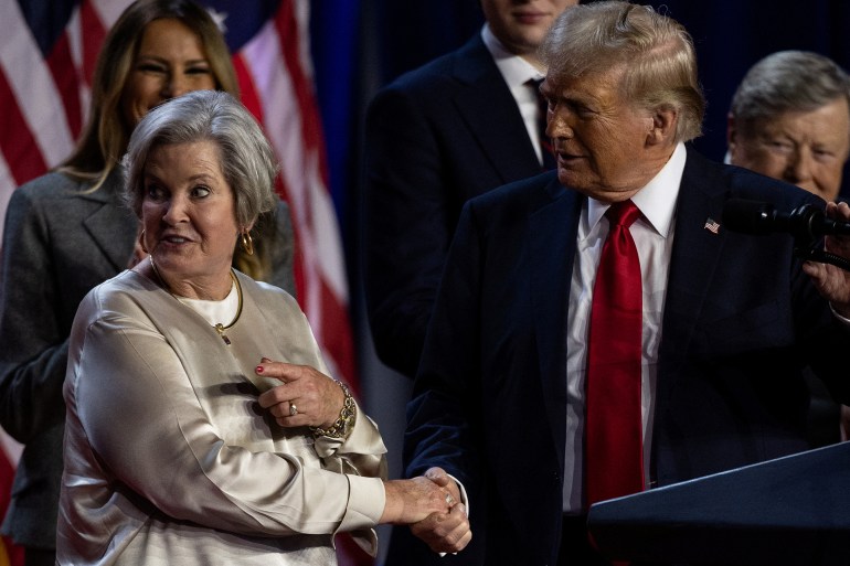 Republican presidential nominee and former U.S. President Donald Trump shakes hands with his senior advisor Susie Wiles as he speaks, following early results from the 2024 U.S. presidential election in Palm Beach County Convention Center, in West Palm Beach, Florida, U.S., November 6, 2024. REUTERS/Carlos Barria