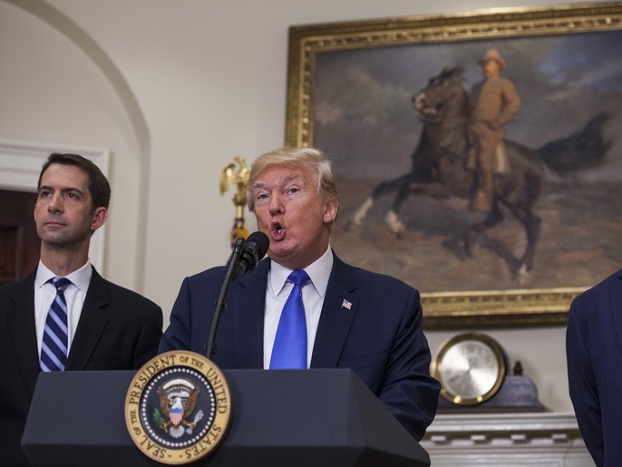 epa06121544 US President Donald J. Trump makes an announcement on the introduction of the Reforming American Immigration for Strong Employment (RAISE) Act with Republican Senator from Arkansas, Tom Cotton (L), and Republican Senator from Georgia. David Perdue (R), in the Roosevelt Room at the White House in Washington, DC, USA, 02 August 2017. The act aims to overhaul US immigration by moving towards a merit based system. EPA/Zach Gibson / POOL