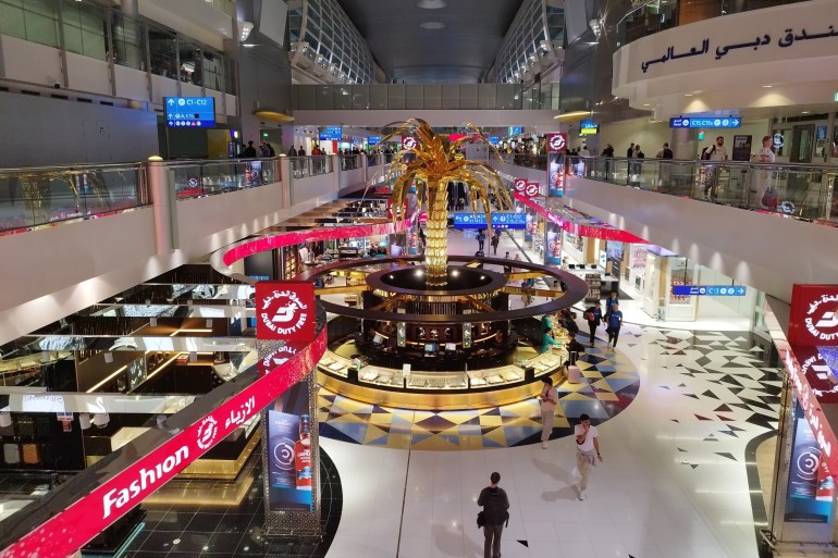 Dubai, UEA - 13 July 2024 - The atmosphere inside Dubai International Airport with shops selling food and gold jewelry, comfortable for international flight transit. ; Shutterstock ID 2491832379; purchase_order: aljazeera ; job: ; client: ; other: