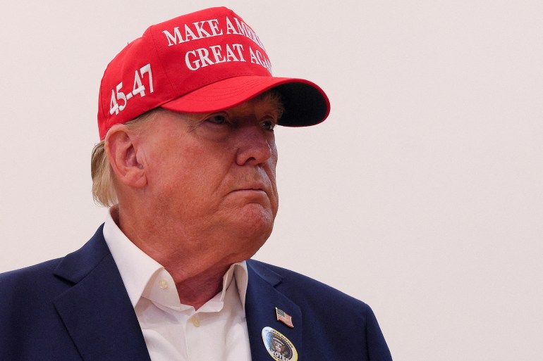 Republican presidential nominee and former U.S. President Donald Trump wears an "I Voted" sticker as he speaks to reporters after voting at Mandel Recreation Center on Election Day in Palm Beach, Florida, U.S., November 5, 2024. REUTERS/Brian Snyder